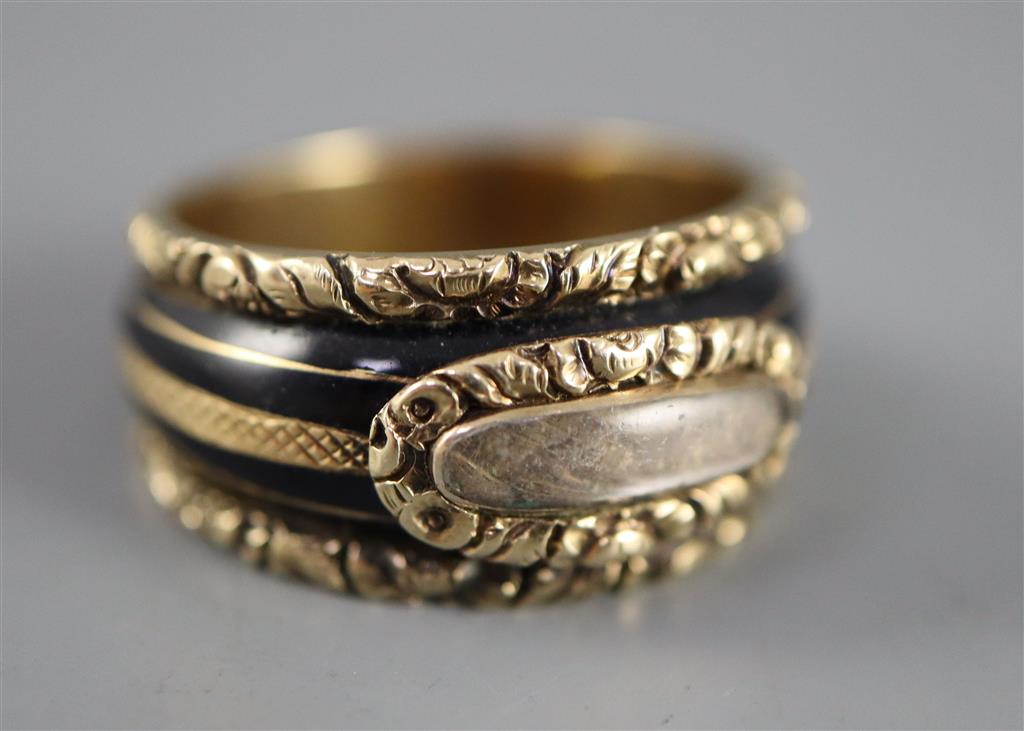 A George III gold and black enamel memorial ring with hairwork panel and a matching brooch,